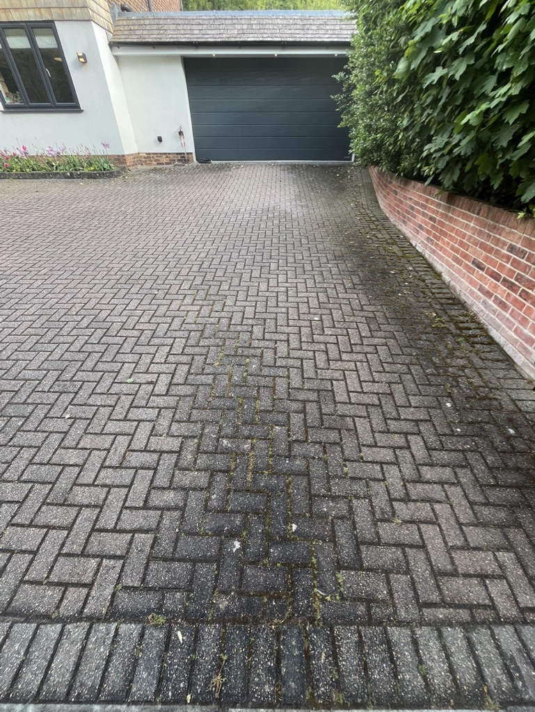 Driveway with moss and staining before cleaning