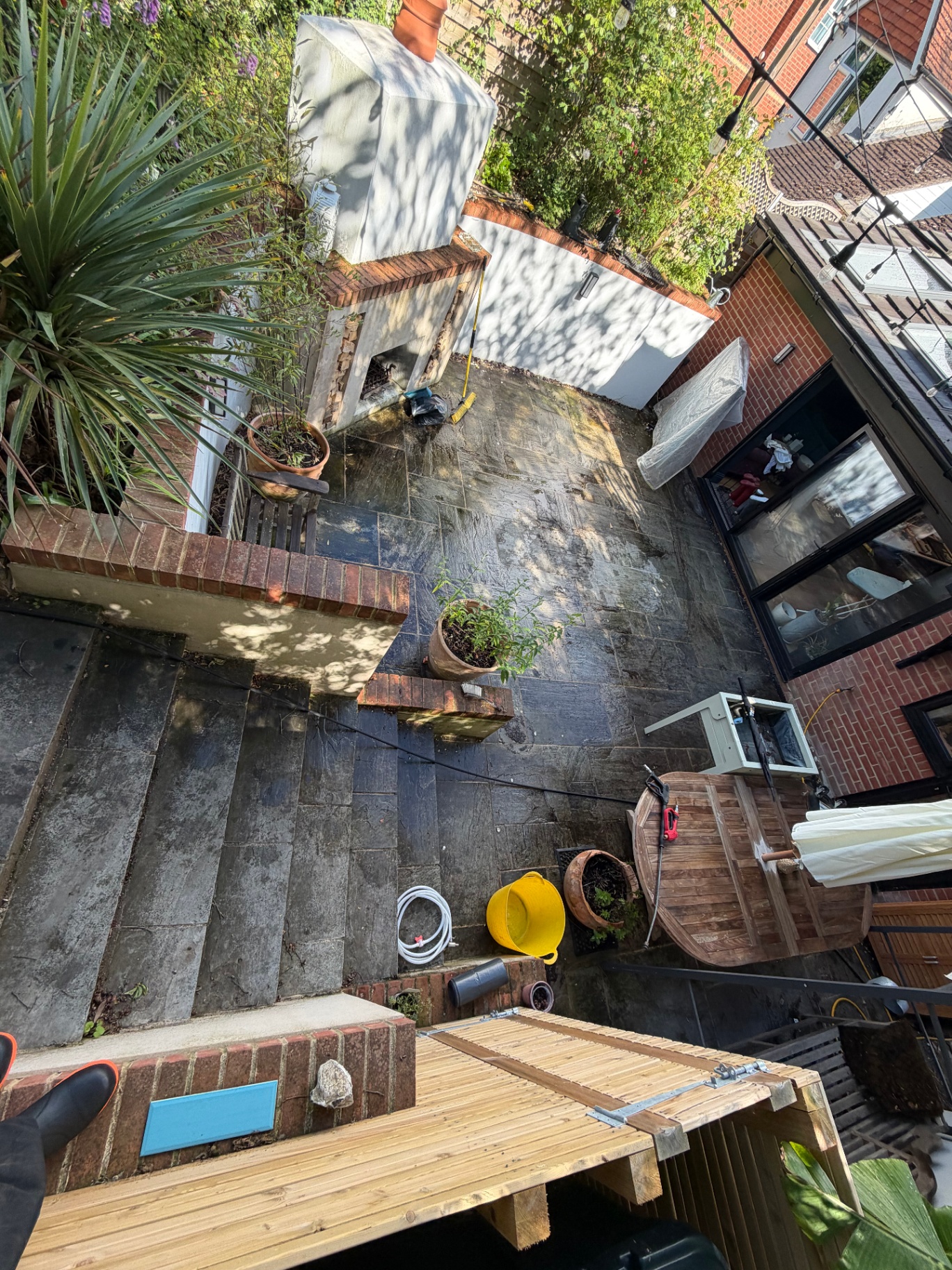 Overhead view of slate patio with dirt and staining before cleaning