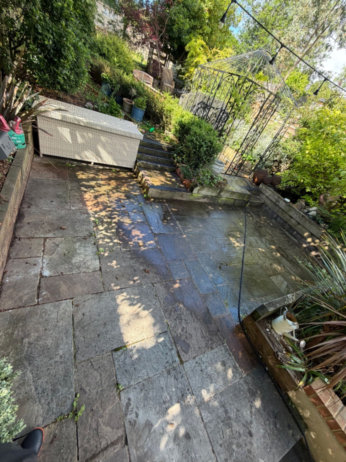 Sandstone patio before cleaning with dirt and algae staining