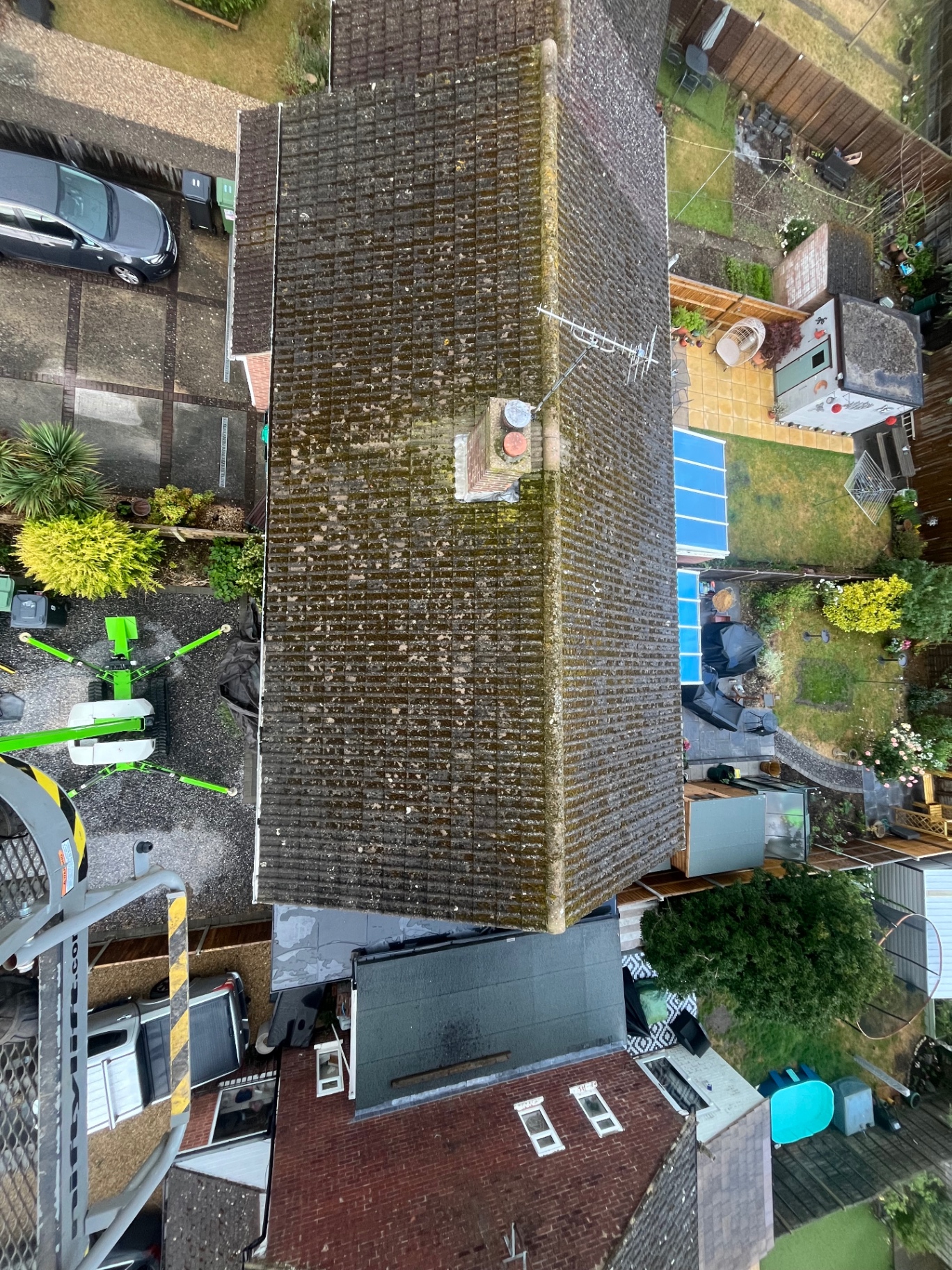Overhead view of a roof covered with moss before cleaning
